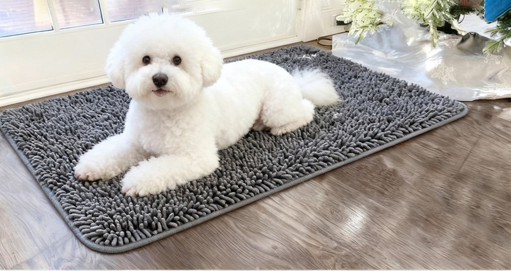 Small white dog lying on a grey chenille hair-trap mat