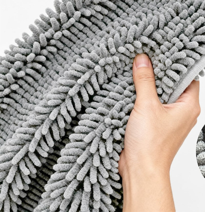 Hand holding the thick chenille pile of the pet mat