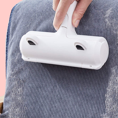 Reusable pet hair roller lifting fur off a grey couch